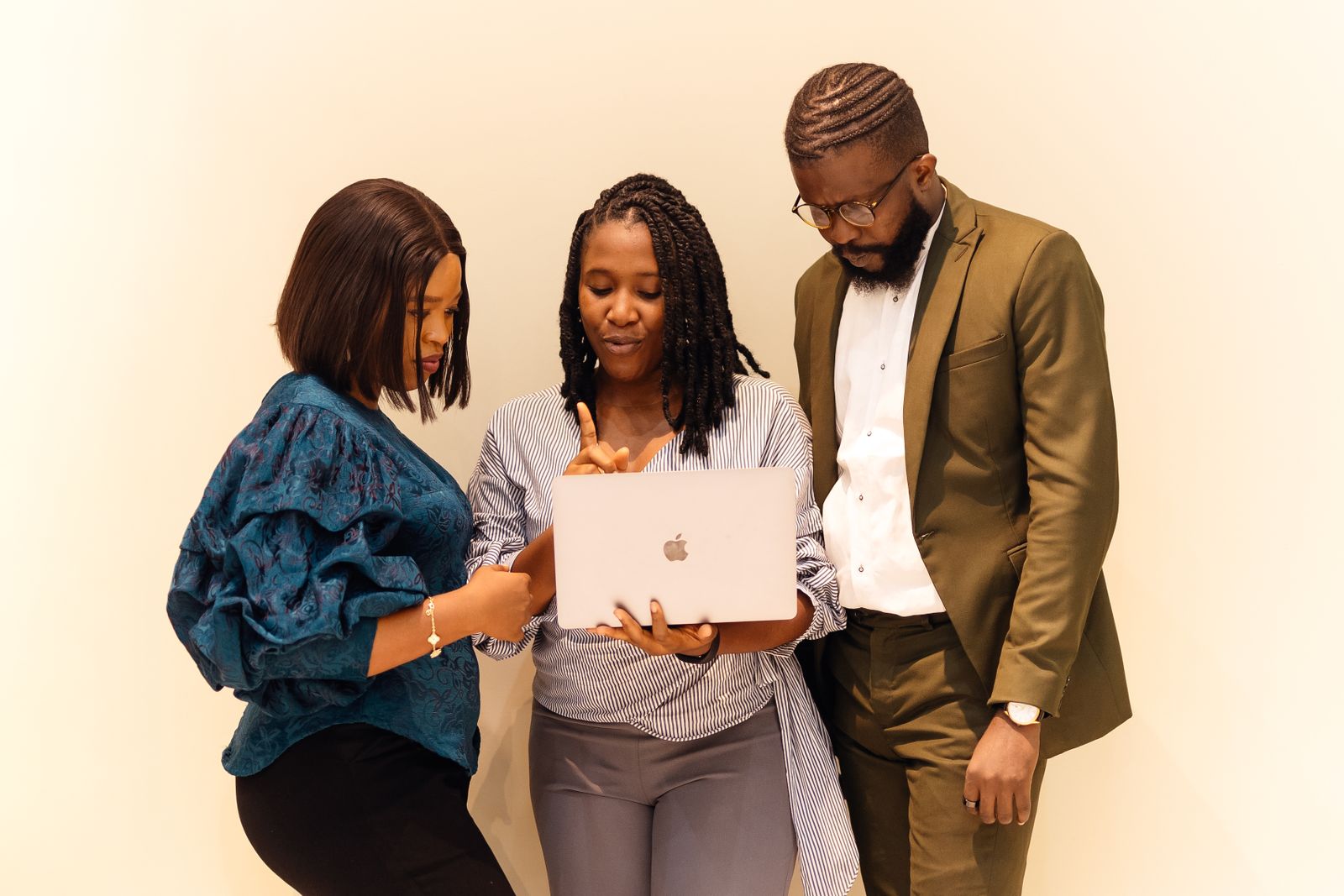 A team of employers collaborating around a laptop